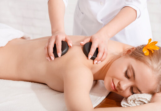Beauty spa treatment and relax concept. Masseur makes procedures for girl
