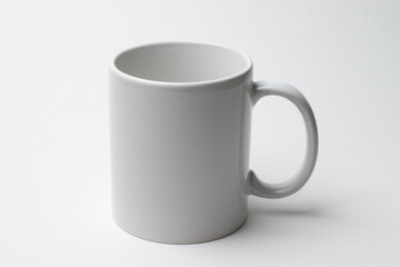 Ceramic white blank mug for drinks on a white background.Ceramic white blank mug for drinks on a white background.
