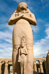 Pharaoh statue with Nefertari at Karnak temple complex in Luxor, Egypt