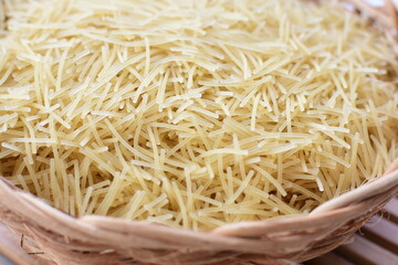 Short pasta spaghetti angel hair displayed in containers on white background