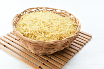 Short pasta spaghetti angel hair displayed in containers on white background