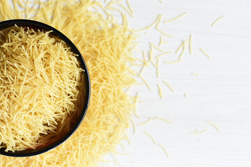 Short pasta spaghetti angel hair displayed in containers on white background
