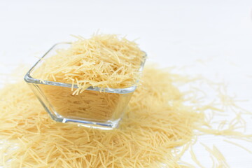 Short pasta spaghetti angel hair displayed in containers on white background