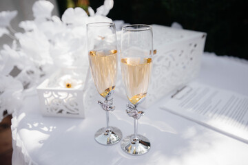 Beautiful decorated holiday glasses with champagne close-up. Holiday glasses