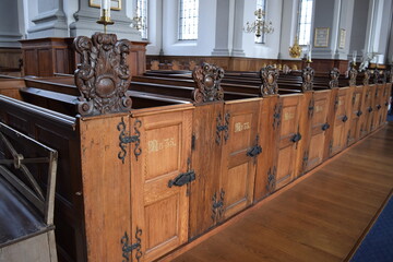 Wooden pews with numbering and metal fittings, Copenhagen, Denmark