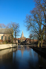 Fototapeta na wymiar Famous Bruges' city canals. Waterfront buildings in Brugge, Belgium.