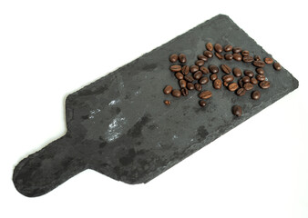 Coffee beans on the stone board and white background. 