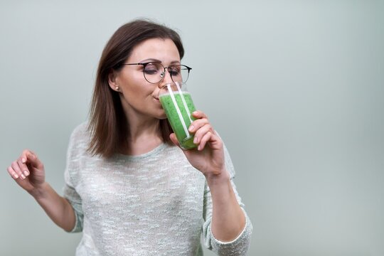 Mature Woman With Green Vegetable Smoothie Drink, Healthy Vegan Diet, Woman Drinking Juice