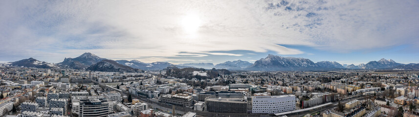 Panoramic aerial drone shot view of Salzburg aiglhof station with view of eastern bavarian alps mountain