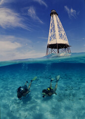 Alligator lighthouse in the Florida Keys with scuba divers swimming by
