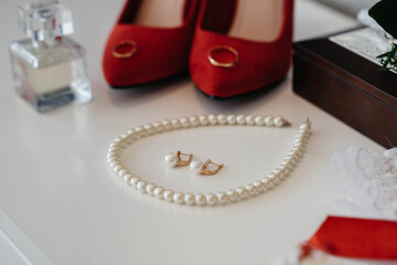 Wedding rings and other accessories close-up during the bride's gathering. Wedding
