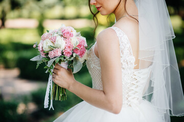 Beautiful and sophisticated wedding bouquet close-up holds the bride in her hands. Wedding bouquet