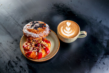 Aroma cappuccino coffee cups with picture and buns with berries