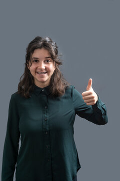 A young girl with ta humb up