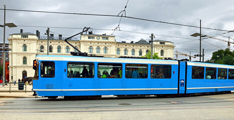 Modern blue tram near railway station in Oslo, Norwey