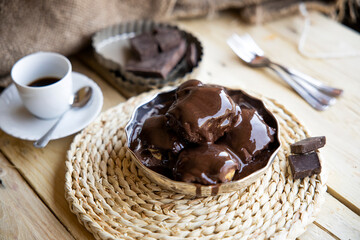 Delicious eclairs with cream and chocolate frosting on a plate
