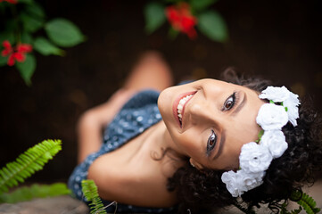 High angle view of a smiling brazilian woman.She has a white flower crown on her head. Selective focus.Copy space