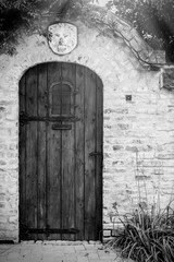 Old wooden door on brick fence wall