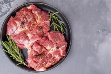 Uncooked pork chop meat ona frying pan. Copyt space, top view