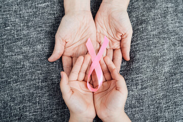 hands with the pink cancer ribbon on their palms