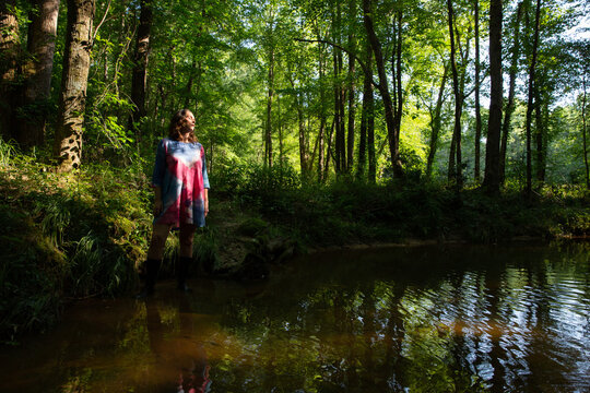 Woman In Colorful Dress Standing In Creek