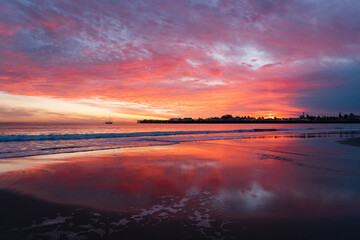 Fototapeta na wymiar Incredible red sunset in Santa Cruz. Red sky on the beach in California 