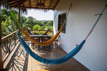 two hammocks on a balcony in summer