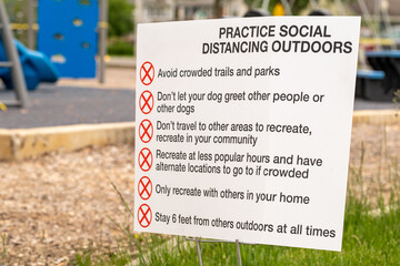 Practice Social Distancing sign in park during Covid 19