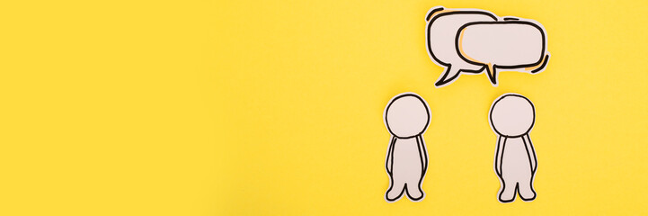 Paper human icon with speech bubble on the yellow
