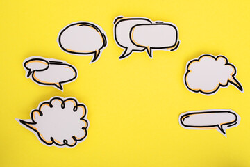 Paper speech bubbles icon on the yellow