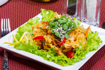 Coleslaw, green leaf lettuce and sesame seeds, selective focus. Table setting. Creative cuisine. As backdrop for menus, cookbooks, advertisements and other culinary projects
