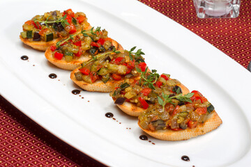 Bruschetta with stewed vegetables and Basil on fried garlic cheese bread. Selective focus. As backdrop for menus, cookbooks, advertisements and other culinary projects