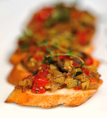 Bruschetta (Italian Toasted Garlic Bread) with stewed vegetables, selective focus. Creative cuisine. As backdrop for menus, cookbooks, advertisements and other culinary projects