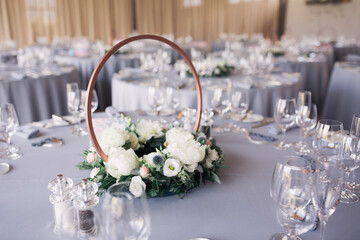 Table decoration at wedding on grey tablecloth