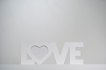 Inscription LOVE with wooden letters on a white background. Valentine's Day.