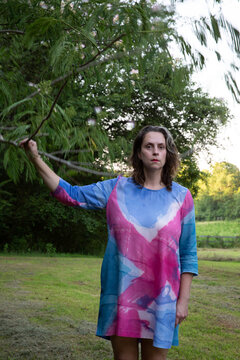 Woman In Colorful Dress In Green Space