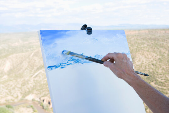 senior woman artist painting landscape, White Rock, New Mexico