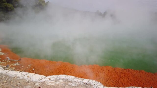 4K left to right panning up close view of the bubbling hot water in the thermal lake called the Champagne Pool at Wai-O-Tapu Thermal Wonderland at Rotorua,North Island,New Zealand