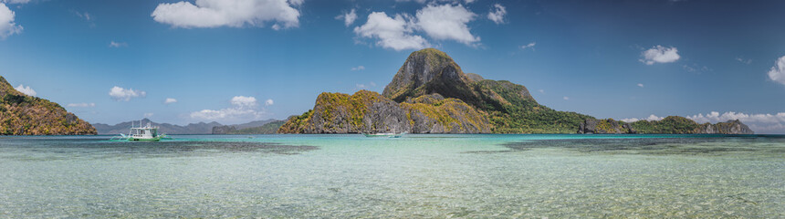 Ultra wide banner of El Nido bay with trip boat and Cadlao island, Palawan, Philippines. Panoramic...