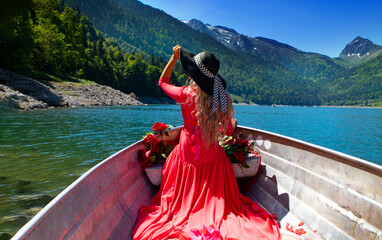 Life style woman with red dress and roses on a lake