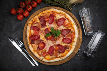 Italian pizza with meat on dark background