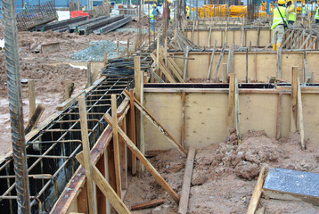 Ground beam timber formwork constructed by workers at the construction site. 