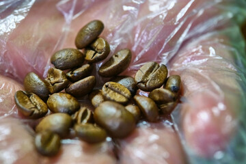 coffee beans on the hands of a man close-up color