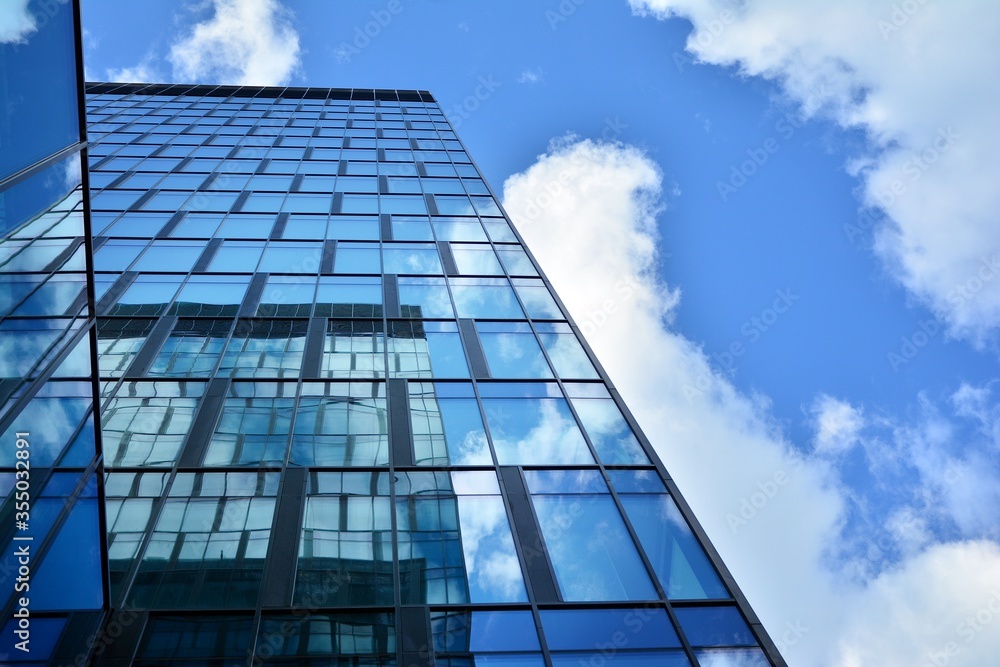 Wall mural facade texture of a glass mirrored office building. fragment of the facade. modern architecture of t