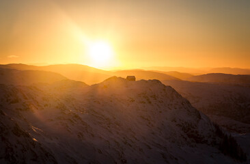 Mountain cabin in winter sun