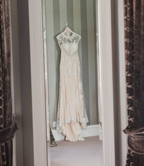 Wedding dress hanging in a mirror