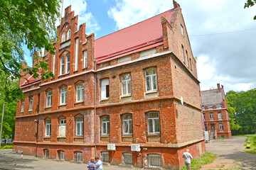 Fototapeta na wymiar SOVETSK, RUSSIA. Side facade of the central city hospital (former House of the Poor, 1908). Kaliningrad region