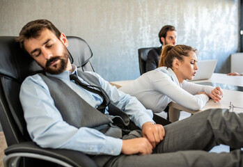 Business people sleeping and taking a break at work