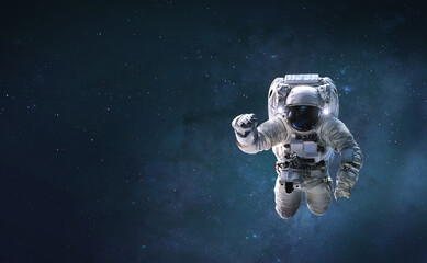 Obraz na płótnie Canvas Astronaut on background with space and stars. Wallpaper for background. Elements of this image furnished by NASA