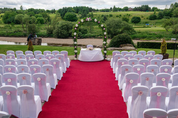 Ceremony set up for outdoor wedding in garden by river